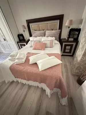 a bedroom with a large bed with towels on it at Un rincón romano in Caldas de Reis