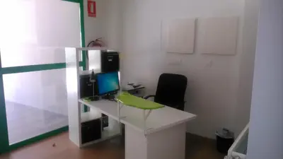 a desk with a computer and a chair in a room at Grelo Hostel in Ourense