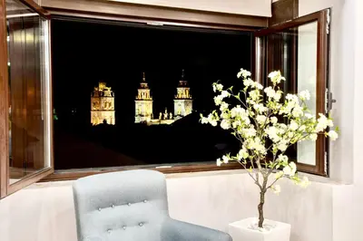 a chair and a window with a view of big ben at Cathedral Boutique by Lugo Collection in Lugo
