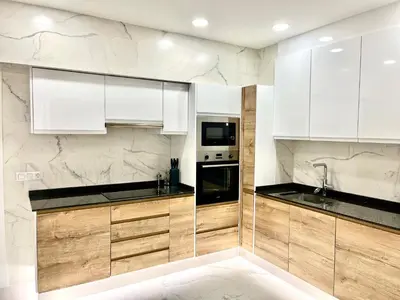 a kitchen with white cabinets and black counter tops at Cathedral Boutique by Lugo Collection in Lugo