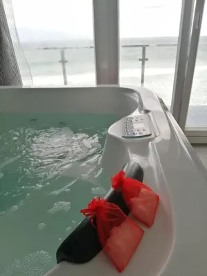 a bath tub with two red bow ties on it at Refugio O Castro in Barreiros