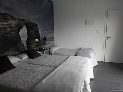 a bedroom with two beds in a room at Refugio O Castro in Barreiros