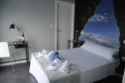 a bedroom with a bed with towels on it at Refugio O Castro in Barreiros