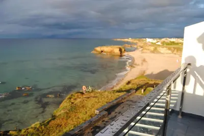 a view of the beach from the balcony of a building at Refugio O Castro in Barreiros