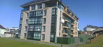 a tall building with windows on the side of it at El apartamento de Ana y Mariano in Foz