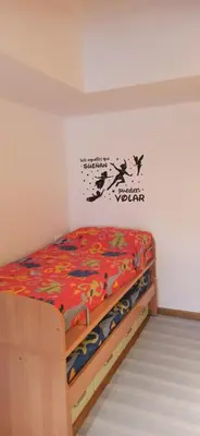 a bedroom with a bed in a room with a wall at El apartamento de Ana y Mariano in Foz