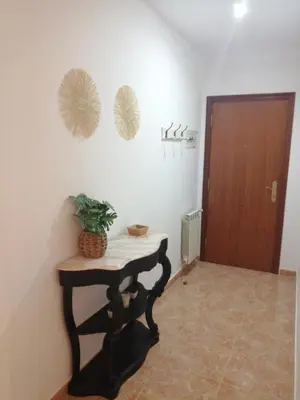 a room with a table with a plant on a wall at Alojamiento Santa Maria Bertamirans II in Ortoño