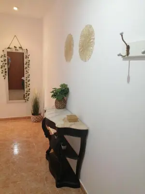 a room with a table and a mirror on the wall at Alojamiento Santa Maria Bertamirans II in Ortoño