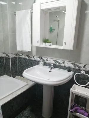 a bathroom with a white sink and a mirror at Alojamiento Santa Maria Bertamirans II in Ortoño