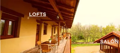 a restaurant with tables and chairs on a building at Apartamentos turísticos LAS CARBALLEDAS in Rabanal del Camino