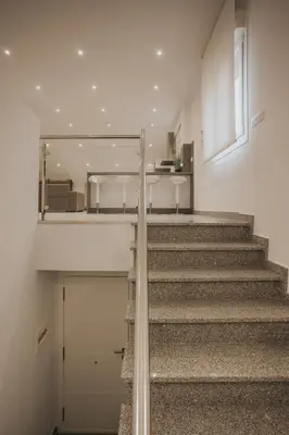 a staircase leading up to a building with a door at Casas del Pedregal apartamento 3 in A Estrada