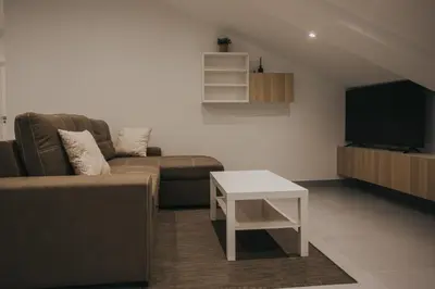 a living room with a couch and a table at Casas del Pedregal apartamento 3 in A Estrada