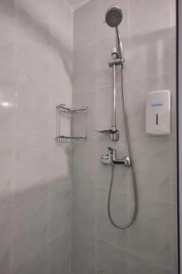 a shower with a shower head in a bathroom at Apartamento de Julia in Santiago de Compostela