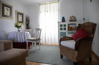 a living room with a table and a chair at Casa San Martiño - Teo in Rua De Francos