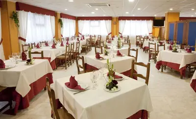 a dining room with white tables and chairs at Casa San Martiño - Teo in Rua De Francos