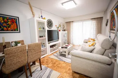 a living room with a couch and a tv at Piso Milà in Ourense