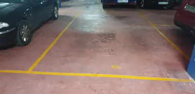 a parking lot with cars parked in it at Piso Milà in Ourense