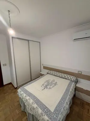 a bedroom with a bed with a blanket on it at Amplio Piso Reformado in Vivero