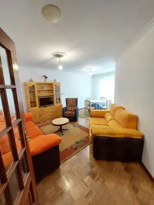 a living room with a couch and two chairs at Amplio Piso Reformado in Vivero
