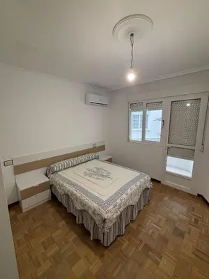 a bedroom with a bed and a window at Amplio Piso Reformado in Vivero