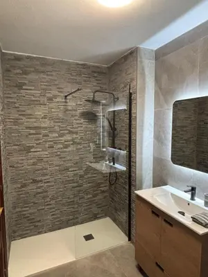 a bathroom with a shower and a sink at Amplio Piso Reformado in Vivero