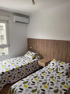 two beds sitting next to each other in a bedroom at Amplio Piso Reformado in Vivero