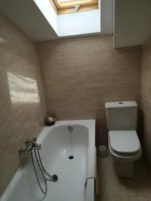 a bathroom with a white tub and a toilet at Tía María in Cerredo