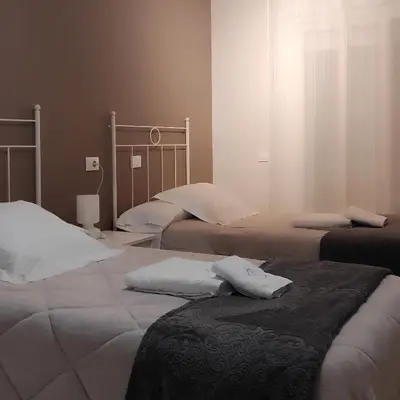 a bedroom with two beds with white pillows on them at Pensión NAVIA A Pontenova in A Pontenova