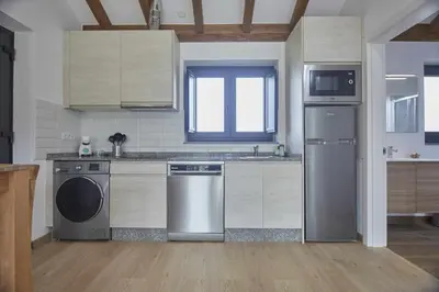 a kitchen with a dishwasher and a washer at Apartamentos Turísticos A Galera - Ribadeo in Ribadeo