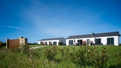 a building with a field in front of it at Apartamentos Turísticos A Galera - Ribadeo in Ribadeo