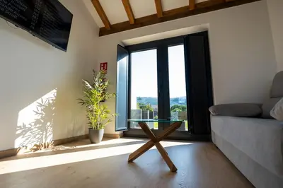 a living room with a glass table and a couch at Apartamentos Turísticos A Galera - Ribadeo in Ribadeo