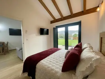 a bedroom with a large bed and a large window at Apartamentos Turísticos A Galera - Ribadeo in Ribadeo