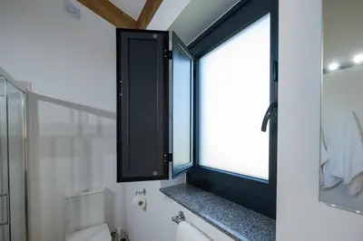 a bathroom with a window and a bath tub at Apartamentos Turísticos A Galera - Ribadeo in Ribadeo