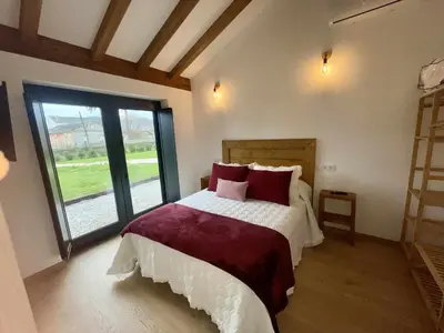a bedroom with a bed and a large window at Apartamentos Turísticos A Galera - Ribadeo in Ribadeo