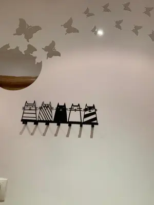 a wall decoration of three cats on a fence with bats at MANSIÓN DEL INDIANO in Viveiro