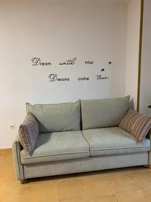 a couch in a living room with words on a wall at MANSIÓN DEL INDIANO in Viveiro