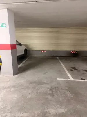 a parking garage with a white car parked in it at MANSIÓN DEL INDIANO in Viveiro