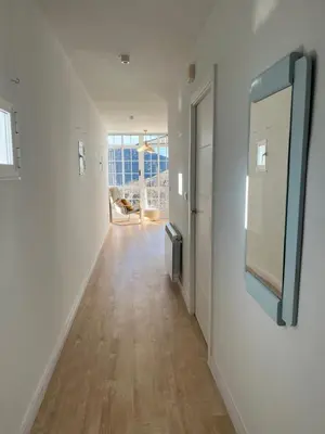 a hallway with white walls and a mirror on a wall at Casa Catalina - Ribeira Sacra in Abeleda