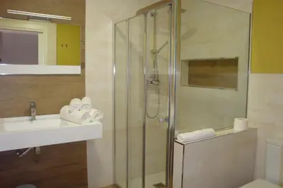 a bathroom with a shower and a sink at Hostal El Recanto in Vega de Valcarce