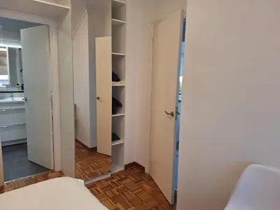 a small room with a closet and a bed at Piso Premium en Casco Histórico Vistas a la Ría Parking in Viveiro