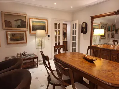 a living room with a table and a dining room at Piso Premium en Casco Histórico Vistas a la Ría Parking in Viveiro