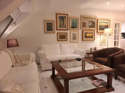 a living room with white furniture and a coffee table at Piso Premium en Casco Histórico Vistas a la Ría Parking in Viveiro