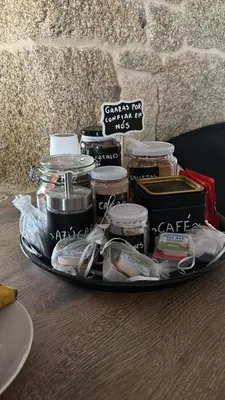 a tray with jars of food on a table at Aturuxo, Casa dos Mestres in Trasmiras