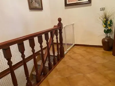 a wooden staircase with a vase of flowers on it at Casa Vilachá - Ribeira Sacra in Puebla del Brollón