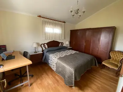 a bedroom with a bed and a table and a desk at Casa Vilachá - Ribeira Sacra in Puebla del Brollón