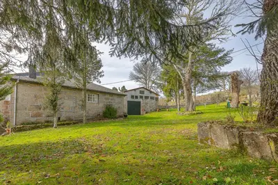 a house with a yard with trees and a building at YourHouse A Casa Dos Cregos in Fonteita