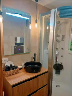 a bathroom with a sink and a mirror and a shower at Piso turistico el Sol VUT-983 in Astorga
