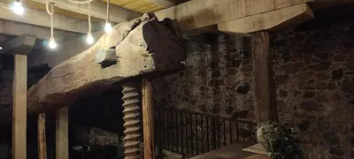 a room with a stone wall and a wall with a rock at la solana del abuelo Andrés in La Chana