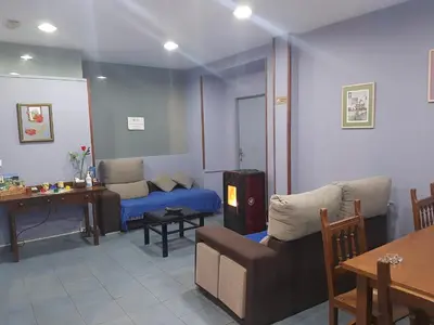 a living room with a couch and a table and a couch at Albergue Berce do Camiño in Tríacastela