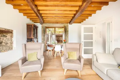 a living room with two chairs and a table at Casa Taboada in San Román